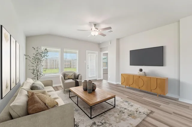 a living room with furniture and a flat screen tv