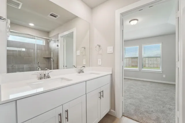 a bathroom with double sink and a mirror