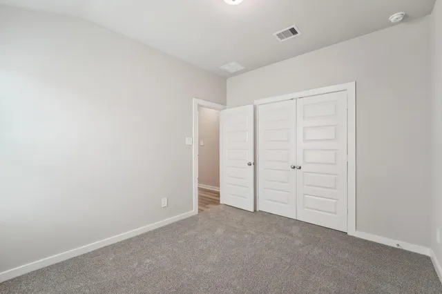 an empty room with closet area