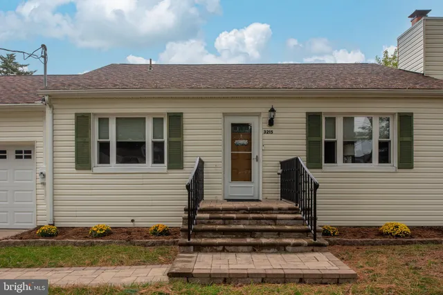 a living room with furniture a fireplace and a window