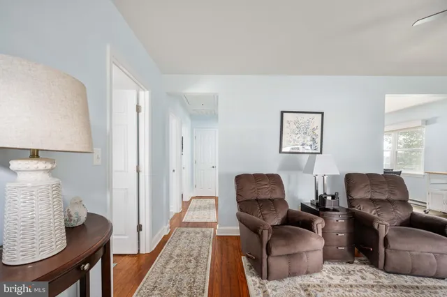 a kitchen with a table chairs sink and cabinets