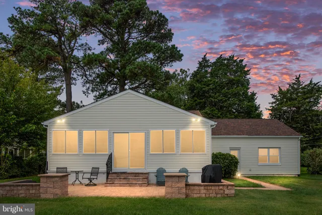 an aerial view of a house with a yard and lake view