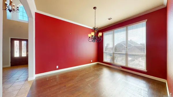 a large white kitchen with a large window