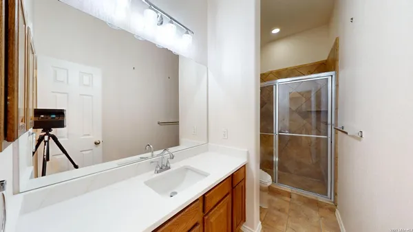 an empty room with wooden floor closet and windows