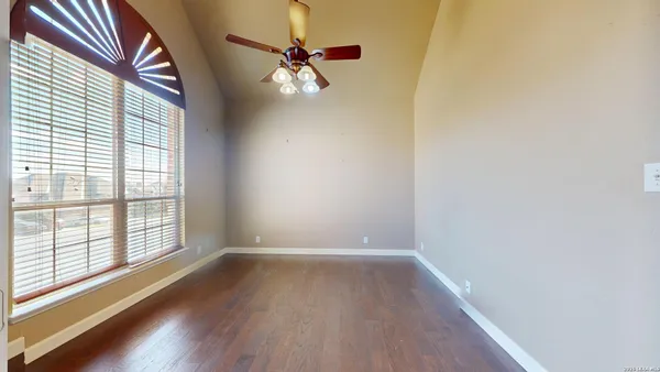 a view of a room with wooden floor and chandelier