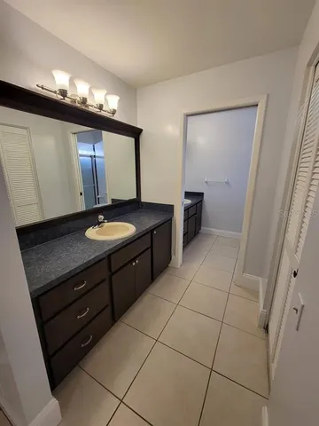 a bathroom with a double vanity sink and mirror