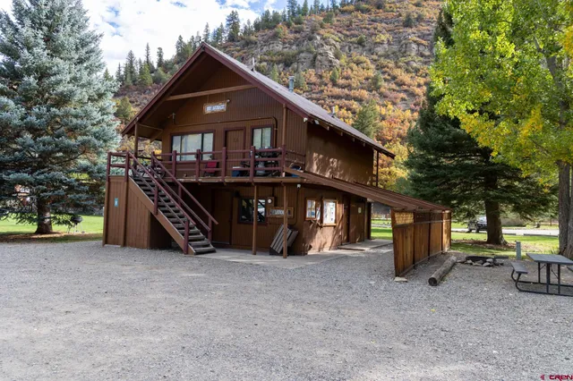 a view of a house with a yard and roof deck