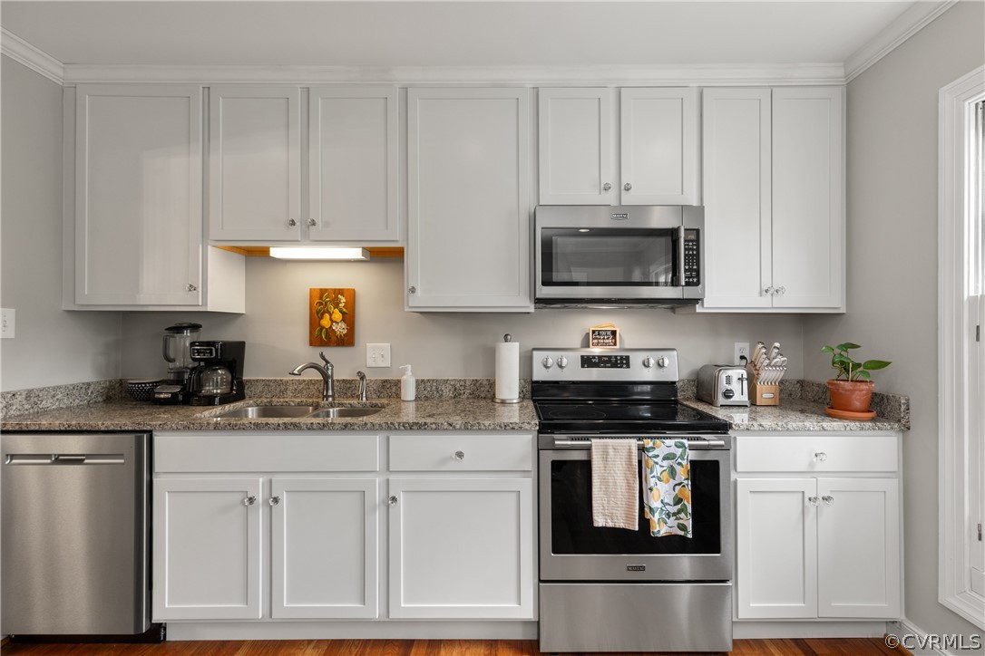 300 North Ridge Road, Unit 33 Henrico, VA 23229 - Photo 17 of 40 a kitchen with stainless steel appliances granite countertop a stove a sink dishwasher and a refrigerator