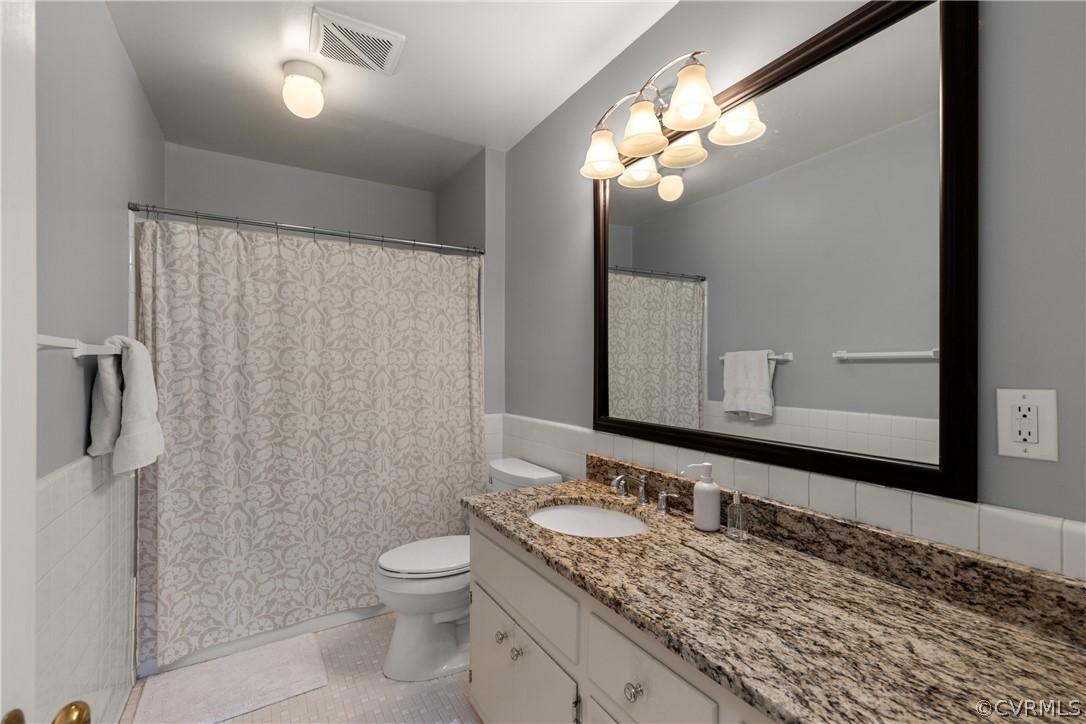 300 North Ridge Road, Unit 33 Henrico, VA 23229 - Photo 31 of 40 a bathroom with a granite countertop sink toilet and shower