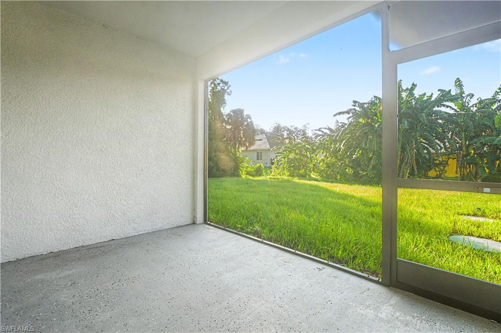 2239 Armour Road Lehigh Acres, FL 33973 - Photo 18 of 24 Screened outdoor area with textured white walls and a gray speckled concrete floor