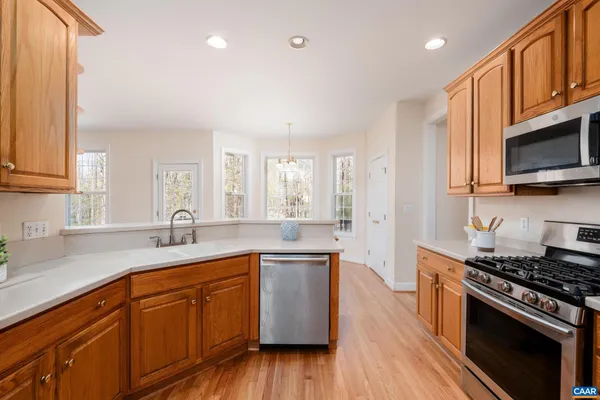 a kitchen with a sink a stove and cabinets