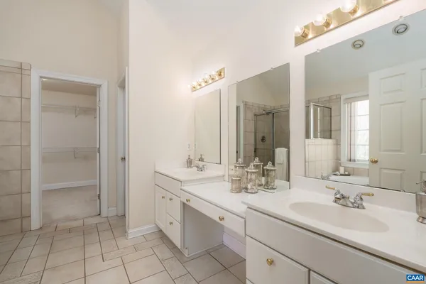a bathroom with a sink double vanity and a mirror