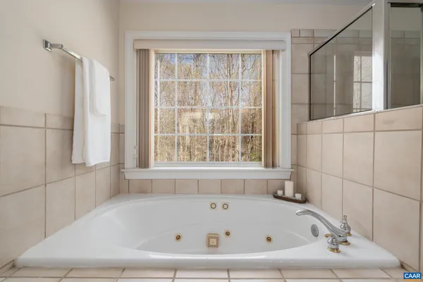a bathroom with bathtub and window