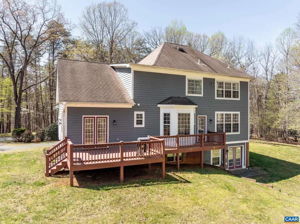 a front view of a house with a yard and balcony