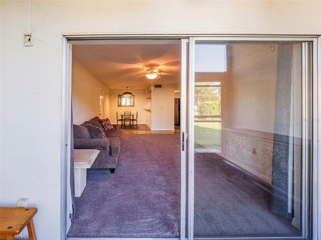 3235 South Beneva Road, Unit 101 Sarasota, FL 34232 - Photo 12 of 36 a living room with furniture and a large window