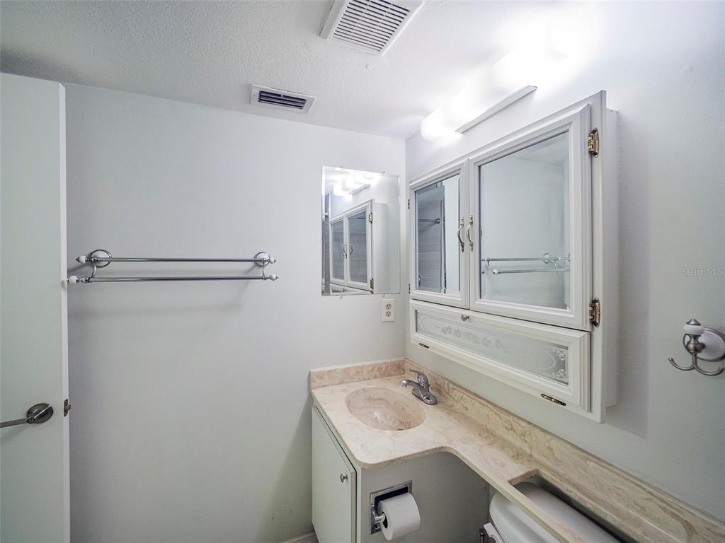 3235 South Beneva Road, Unit 101 Sarasota, FL 34232 - Photo 24 of 36 a bathroom with a granite countertop sink mirror and vanity