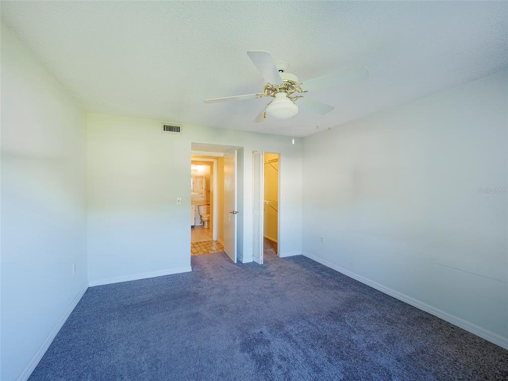 3235 South Beneva Road, Unit 101 Sarasota, FL 34232 - Photo 27 of 36 an empty room with a empty space and a ceiling fan