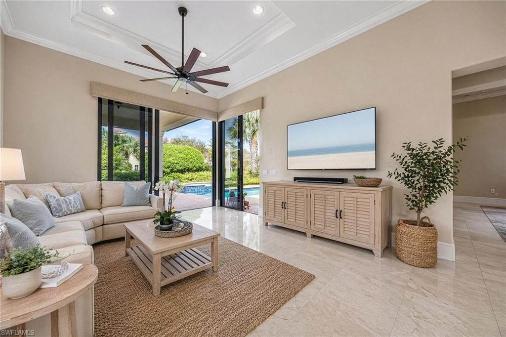 2277 Residence Circle Naples, FL 34105 - Photo 13 of 41 a living room with furniture fireplace and flat screen tv