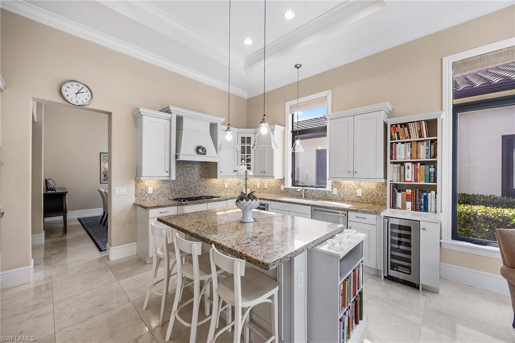 2277 Residence Circle Naples, FL 34105 - Photo 13 of 50 a kitchen that has a lot of cabinets in it and cabinets