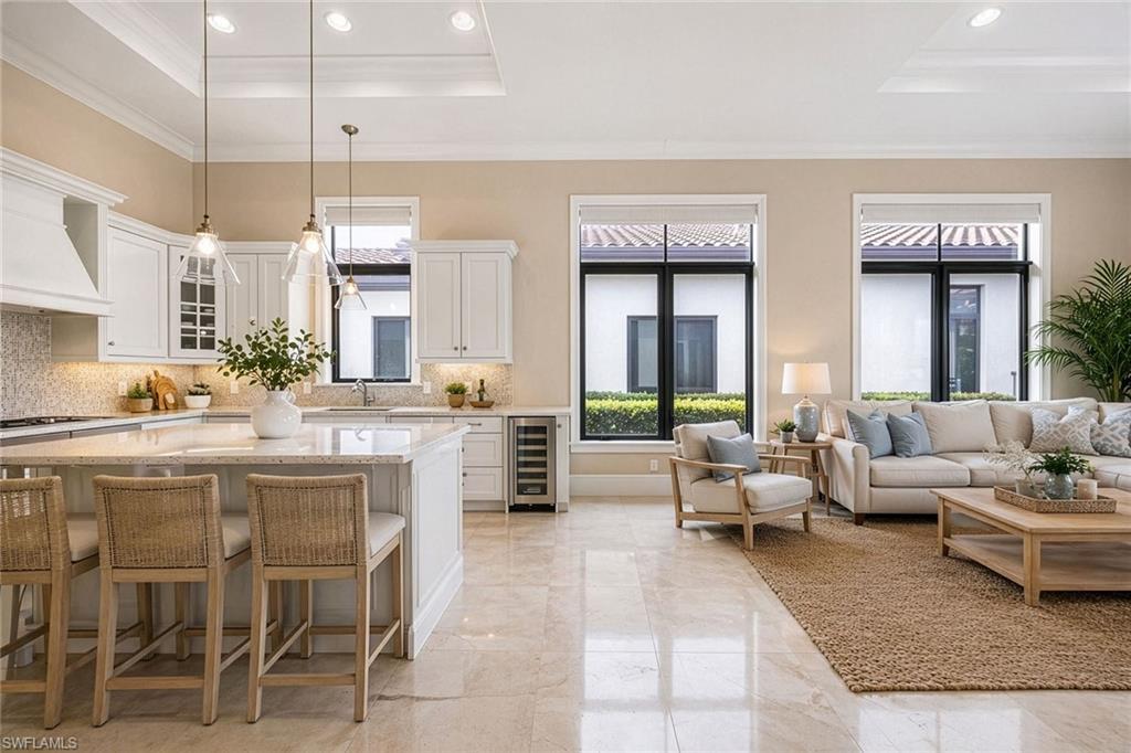 2277 Residence Circle Naples, FL 34105 - Photo 14 of 41 a large living room with granite countertop lots of white furniture and a chandelier