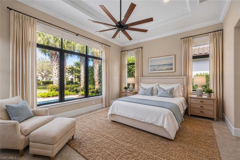 2277 Residence Circle Naples, FL 34105 - Photo 16 of 41 a bedroom with a large bed couch and a large window