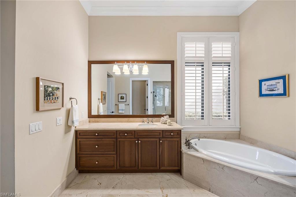 2277 Residence Circle Naples, FL 34105 - Photo 18 of 50 a bathroom with a tub a sink and a window