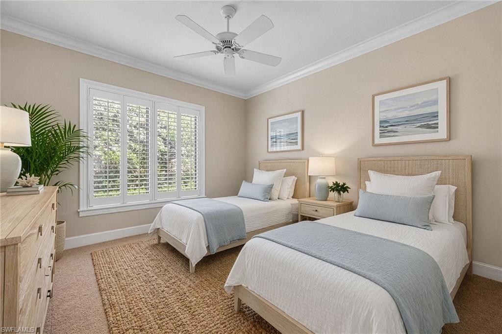 2277 Residence Circle Naples, FL 34105 - Photo 18 of 41 a bedroom with two beds and a potted plant