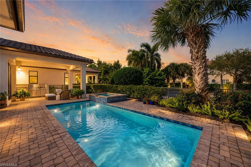 2277 Residence Circle Naples, FL 34105 - Photo 2 of 41 a view of swimming pool with lawn chairs and plants