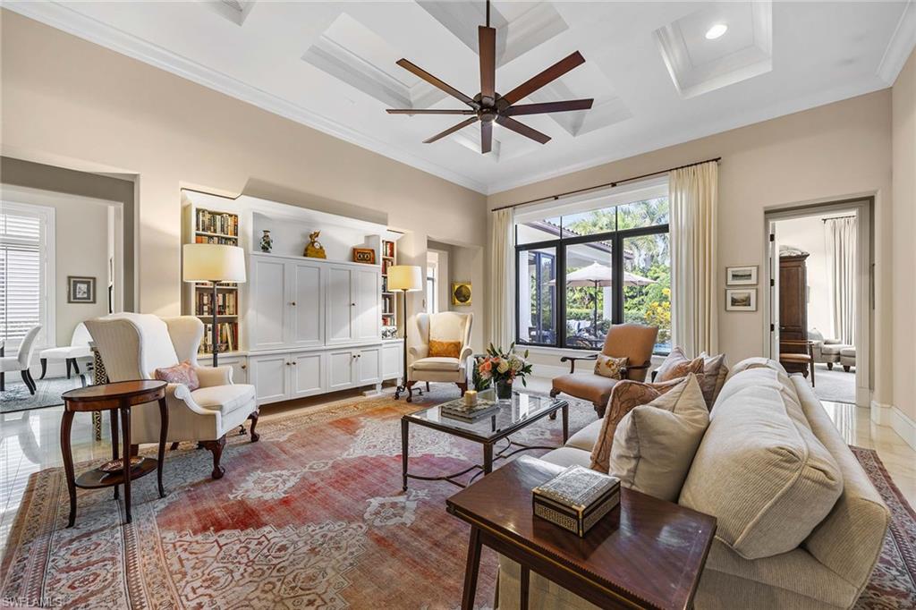 2277 Residence Circle Naples, FL 34105 - Photo 22 of 41 a living room with furniture a ceiling fan and a large window