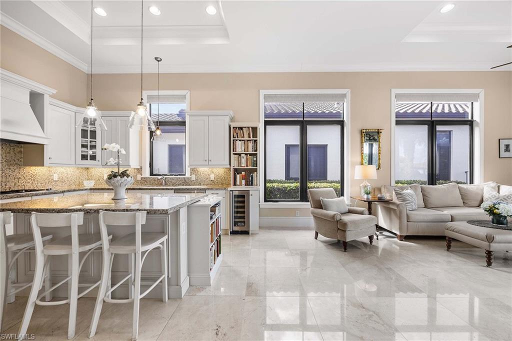 2277 Residence Circle Naples, FL 34105 - Photo 23 of 41 a living room with furniture kitchen view and a large window