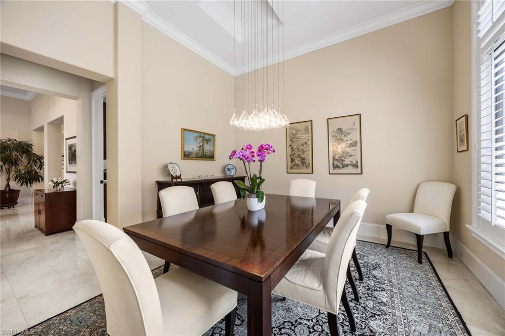 2277 Residence Circle Naples, FL 34105 - Photo 25 of 50 a view of a dining room with furniture and wooden floor