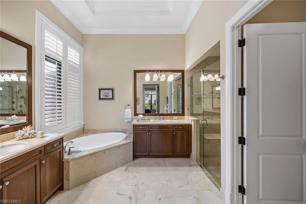 2277 Residence Circle Naples, FL 34105 - Photo 26 of 41 a bathroom with a granite countertop tub sink and mirror