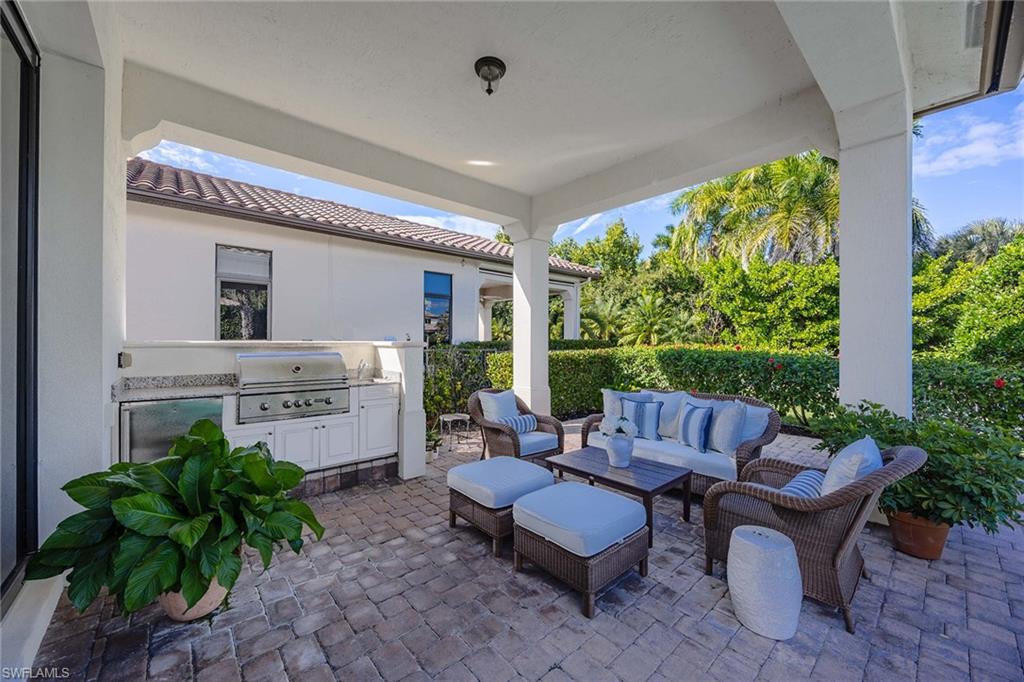 2277 Residence Circle Naples, FL 34105 - Photo 28 of 50 a living room with furniture and a garden