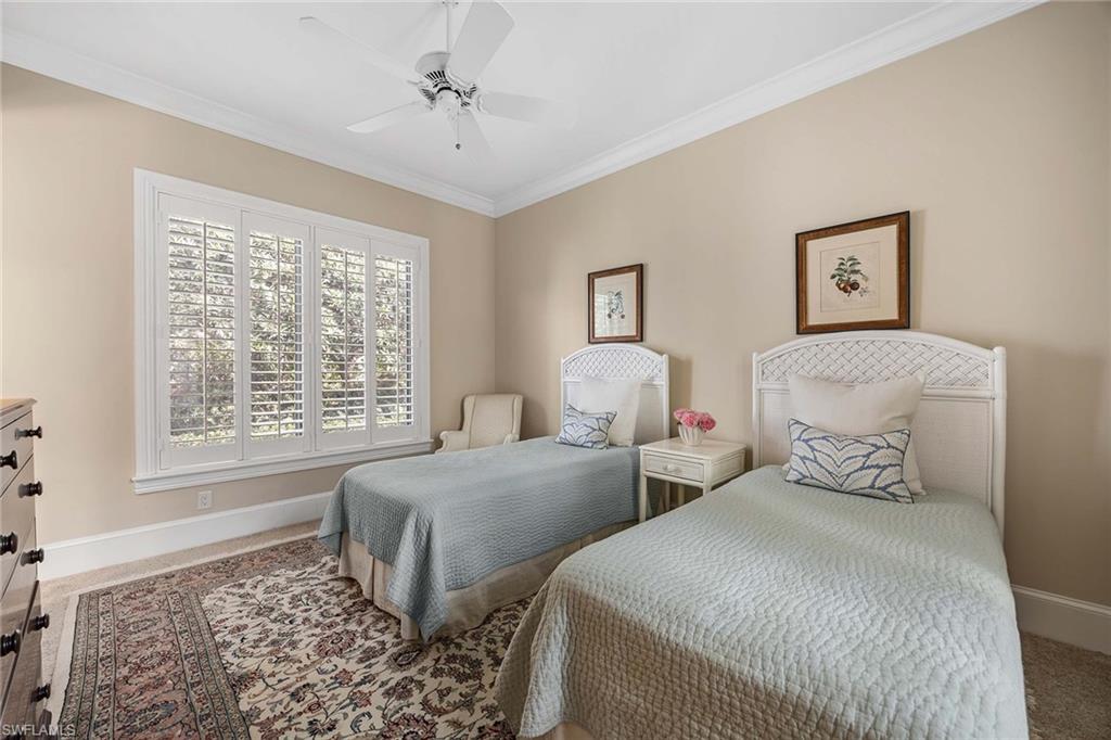 2277 Residence Circle Naples, FL 34105 - Photo 28 of 41 a bedroom with two beds and a window