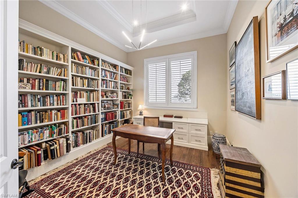 2277 Residence Circle Naples, FL 34105 - Photo 30 of 41 a room with a couch and a bookshelf