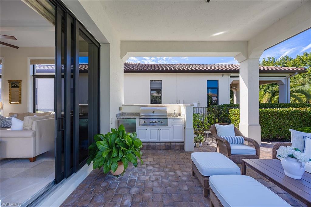 2277 Residence Circle Naples, FL 34105 - Photo 31 of 50 a living room with furniture a fireplace and a potted plant