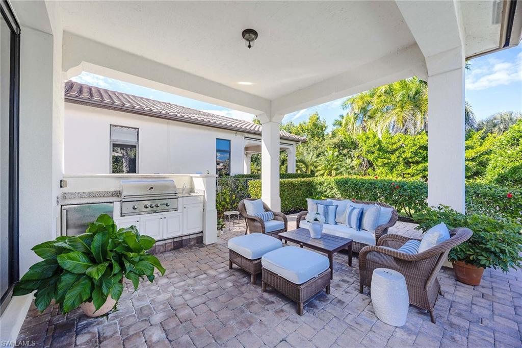 2277 Residence Circle Naples, FL 34105 - Photo 4 of 41 a living room with furniture and a garden
