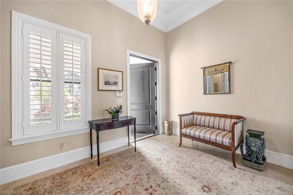 2277 Residence Circle Naples, FL 34105 - Photo 7 of 50 a living room with furniture and a window