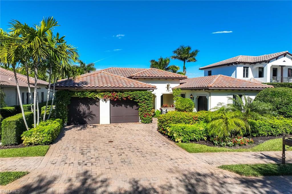 2277 Residence Circle Naples, FL 34105 - Photo 7 of 41 a front view of a house with garden