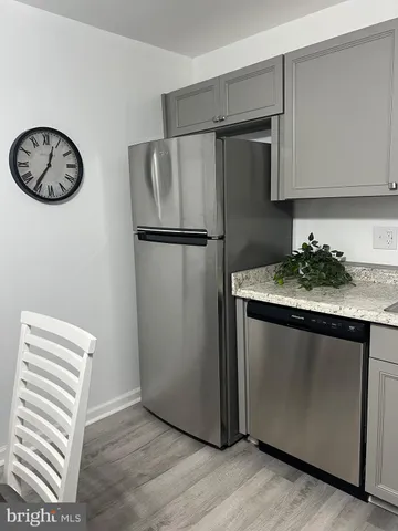 a kitchen with cabinets appliances a sink and a counter top space