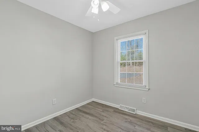 a view of an empty room and wooden floor