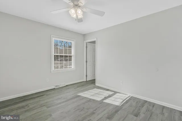 a backyard of house with a swing chair and entertaining space