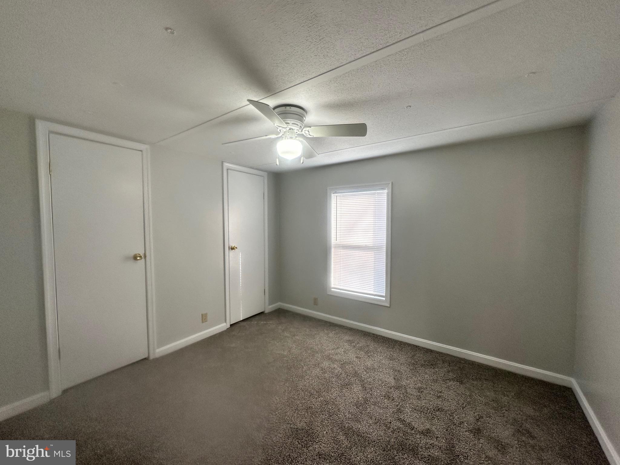 16335 Abbotts Pond Road Milford, DE 19963 - Photo 9 of 18 an empty room with windows and fan