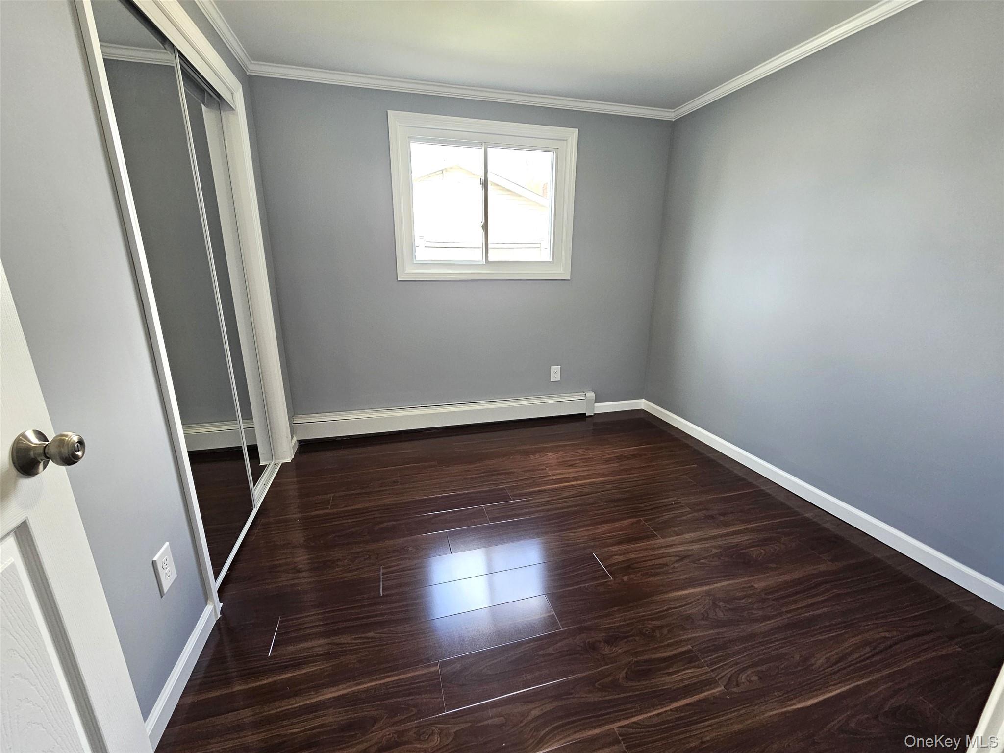 114 Granny Road Farmingville, NY 11738 - Photo 13 of 22 wooden floor in an empty room with a window