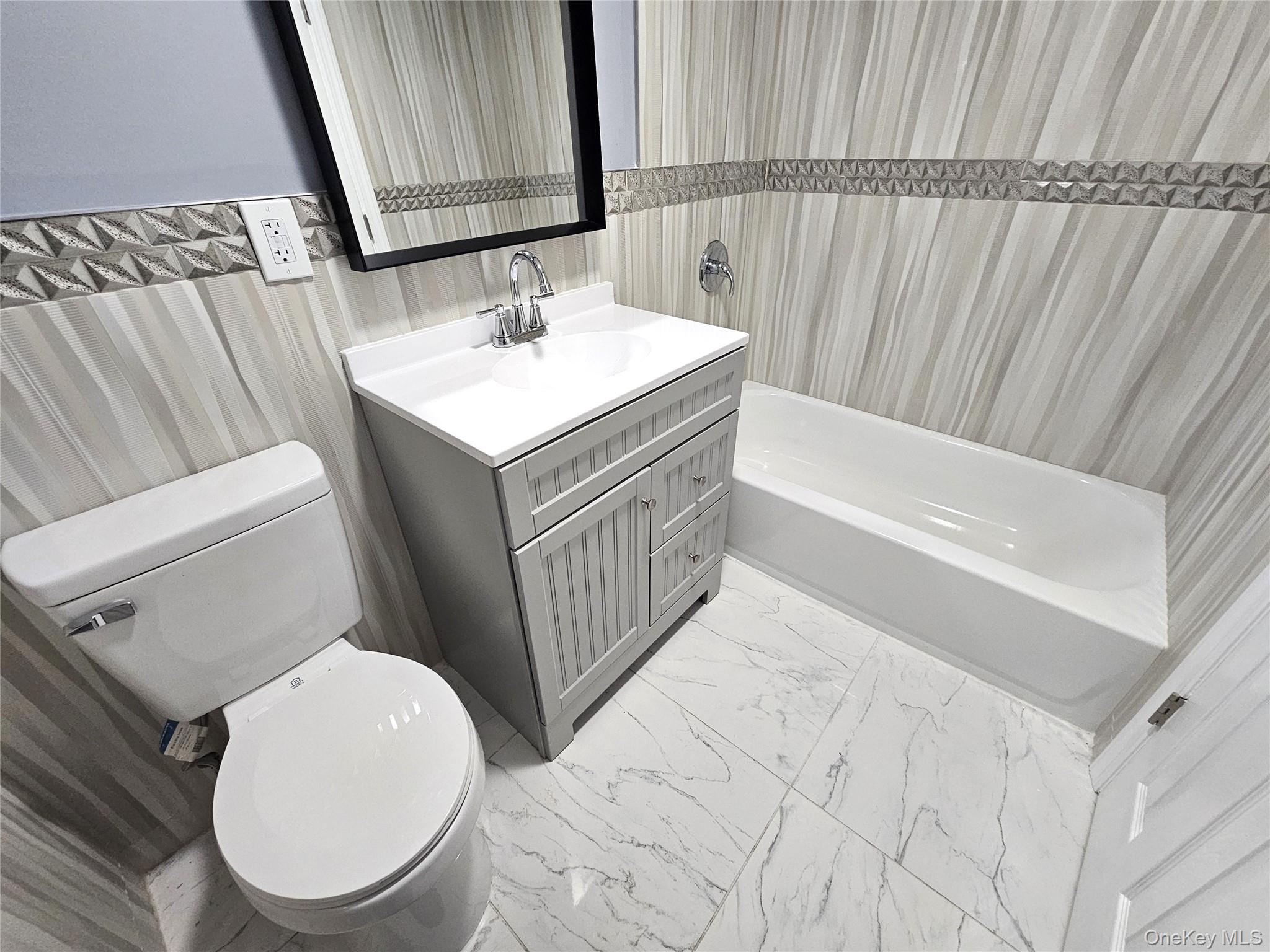 114 Granny Road Farmingville, NY 11738 - Photo 14 of 22 a bathroom with a sink a toilet and a bathtub