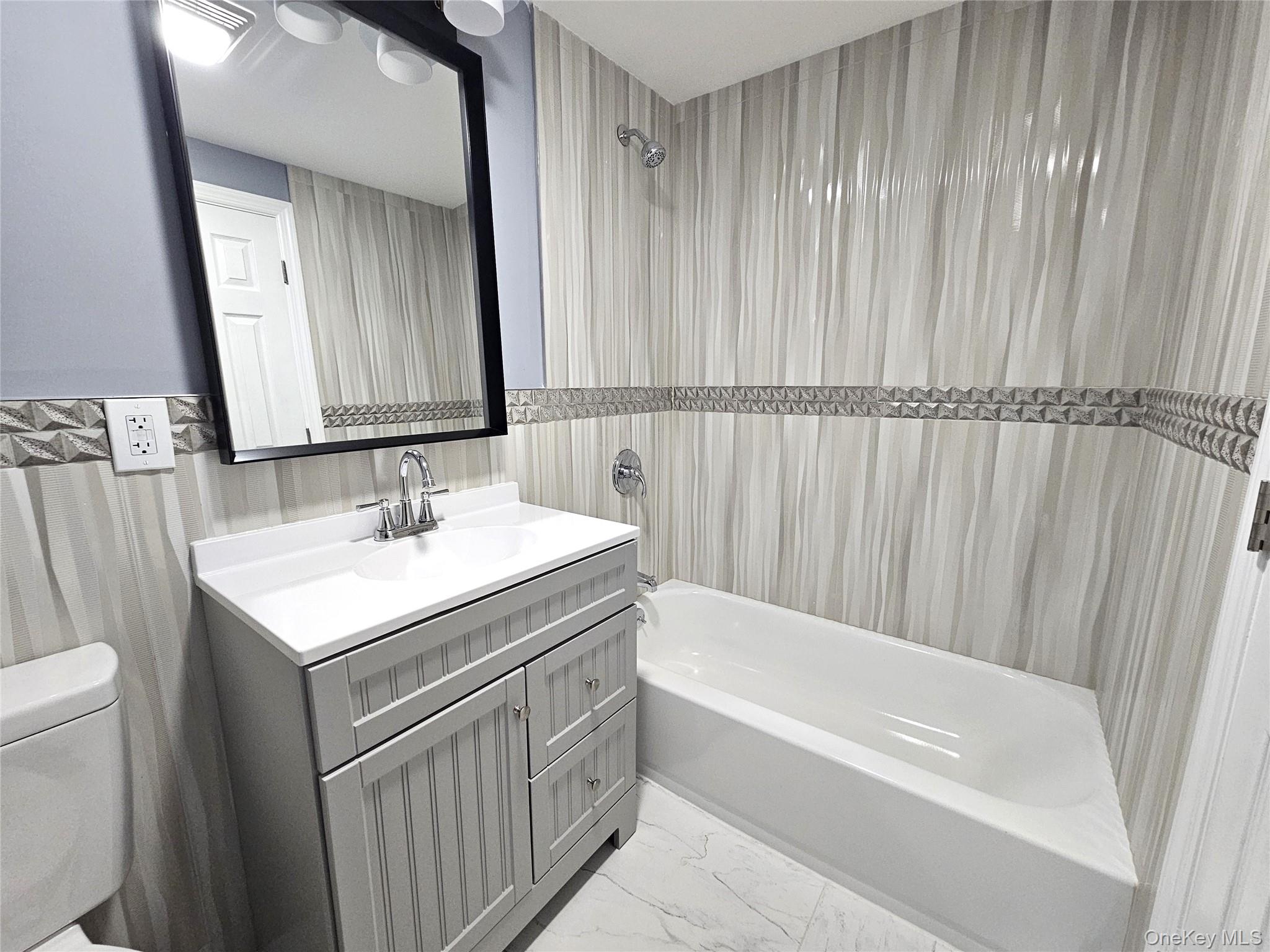 114 Granny Road Farmingville, NY 11738 - Photo 15 of 22 a bathroom with a sink and a bathtub