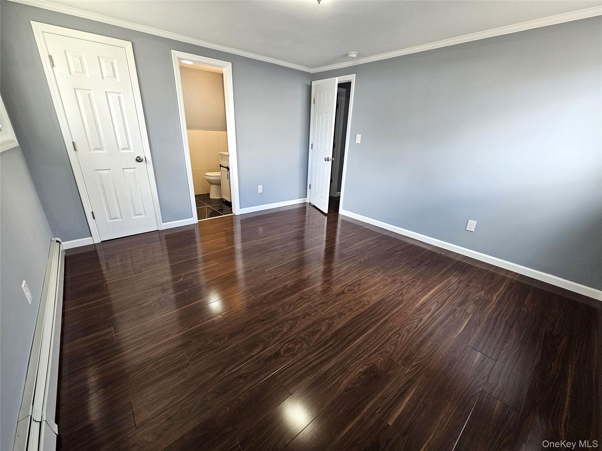 114 Granny Road Farmingville, NY 11738 - Photo 17 of 22 an empty room with wooden floor and windows
