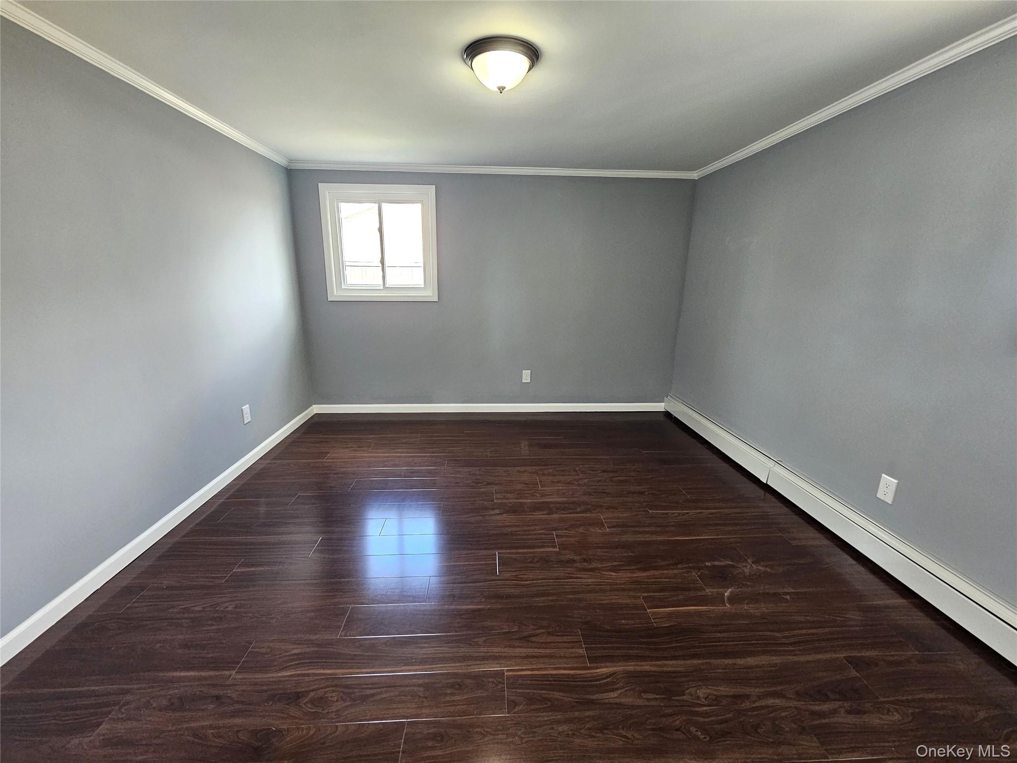 114 Granny Road Farmingville, NY 11738 - Photo 18 of 22 a view of an empty room with wooden floor and window