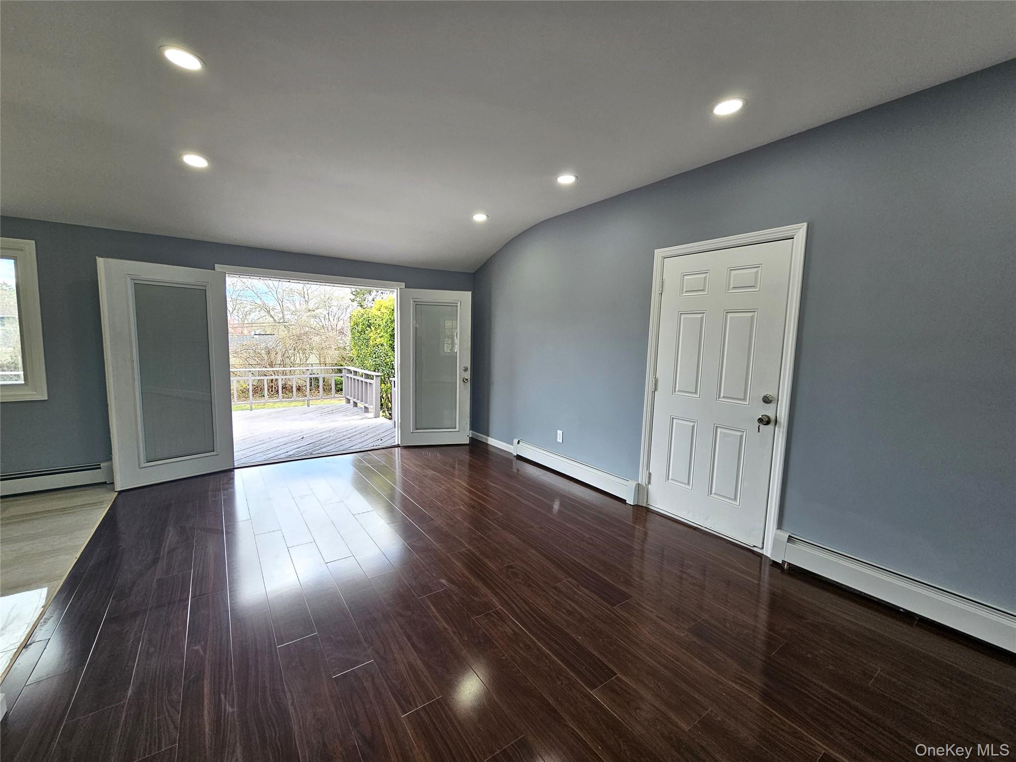 114 Granny Road Farmingville, NY 11738 - Photo 21 of 22 an empty room with wooden floor and windows