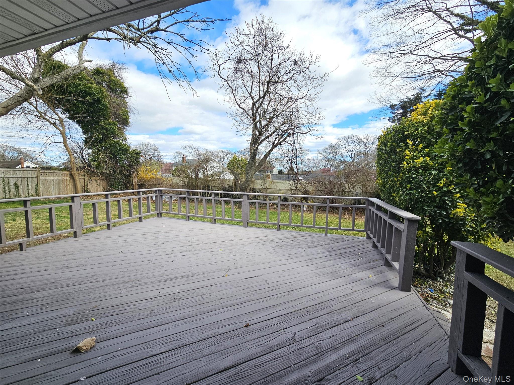 114 Granny Road Farmingville, NY 11738 - Photo 22 of 22 a view of deck with wooden floor and fence next to a yard